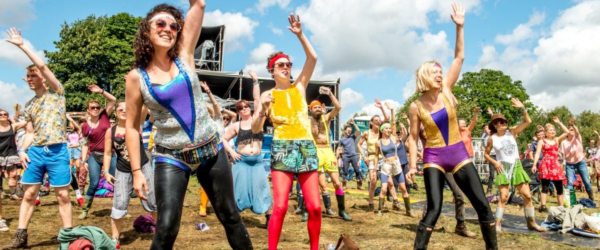 Festival attendees doing aerobics with Mr Motivator in the sunshine